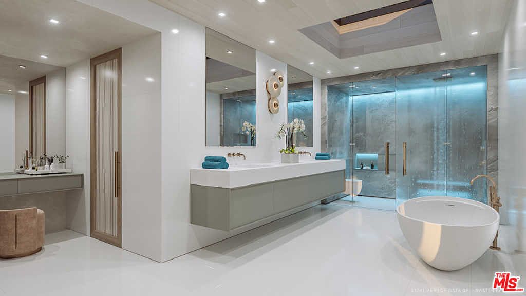 Primary bath with sculpted soaking tub and rain shower